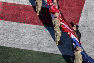 Indiana University's Army ROTC cadets raise the American flag during a football game against the University of Washington. 
