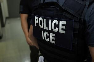Back of jacket that says "Police/ICE"