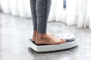 Young girl on home scale
